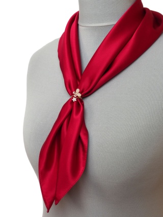 A clip for a scarf, a buckle for a scarf or shawl, a bow with pearls